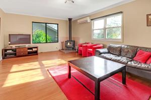 a living room with a couch and a table at Elouera in Mansfield