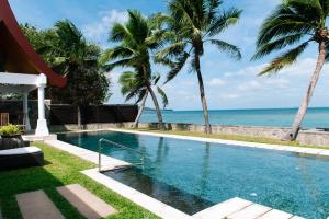 a swimming pool with a view of the ocean at Miskawaan Villa Sila in Mae Nam