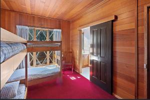 a room with two bunk beds and a door at Lumi Talo in Merrijig