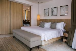 a bedroom with a large bed and a chair at Miskawaan Villa Sila in Mae Nam +22 photos