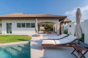 a backyard with a swimming pool and a house at Orchid Paradise Homes OPV422 in Hua Hin