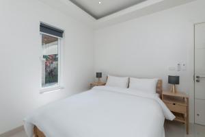 a white bedroom with a white bed and a window at Orchid Paradise Homes OPV422 in Hua Hin +18 photos