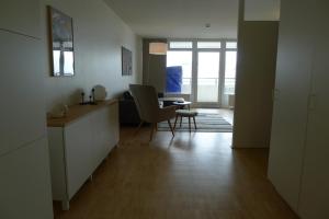 a kitchen with a table and chairs in a room at Panorama Whg 73, 5 OG in Cuxhaven