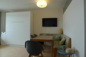 a living room with a couch and a table at Panorama Whg 73, 5 OG in Cuxhaven