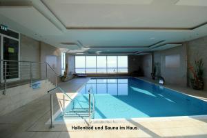 a large swimming pool in a building at Panorama Whg 62, 4 OG in Cuxhaven +14 photos