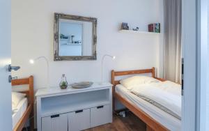 a bedroom with a bed and a mirror on the wall at Panorama Whg 42, 2 OG in Cuxhaven +13 photos
