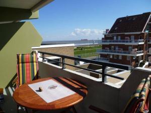 a table on a balcony with a view of a building at Panorama Whg 42, 2 OG in Cuxhaven