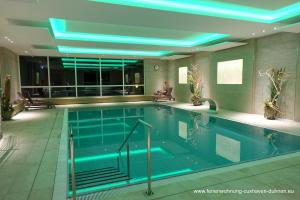 a swimming pool with blue lights in a building at Panorama Whg 42, 2 OG in Cuxhaven