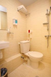 a bathroom with a toilet and a sink at The Cultural Crashpad - 康乃馨旅館 in Hong Kong