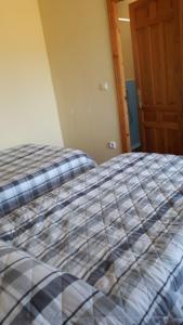 a bed with a checkered blanket in a room at Oasis Montana peace in Tabernas Desert in Tabernas