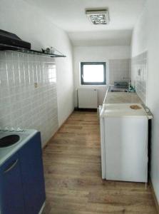 a small kitchen with a stove and a refrigerator at Apartman Borići in Soko Banja