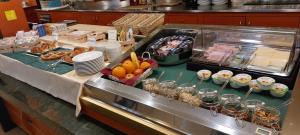 a buffet line with food on a counter in a restaurant at Felix Hotel in Montecchio Maggiore