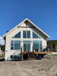 a large white house with a large window at Brand New Collieries Guest House with Fireplace in Nordegg