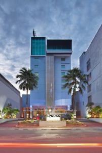 a building with a starbucks sign in front of it at Sparks Life Jakarta, ARTOTEL Curated in Jakarta
