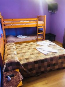 a bedroom with a bunk bed with a bedspread on it at Hostal Amanecer in Fuentebureba