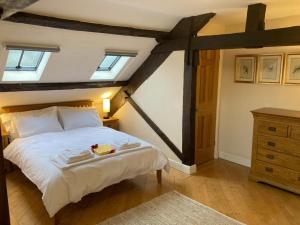 um quarto com uma grande cama branca e 2 clarabóias em Amazing 2BD Apartment -Upper floors of Dufton Hall em Dufton