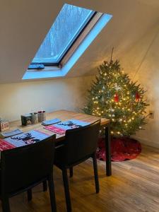 a dining room with a christmas tree and a table and chairs at Catskills Barn Apt on 34 acre Estate with Mountain views in Delhi