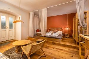 a bedroom with a bed and a table and chairs at In2theRooms Giovanni in Punat