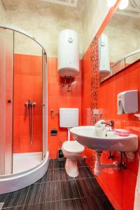 a bathroom with a sink and a toilet and a shower at Apartmani Paulina in Rijeka