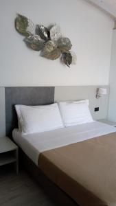 a bedroom with a bed with areath on the wall at Hotel Cinzia in Porto Garibaldi