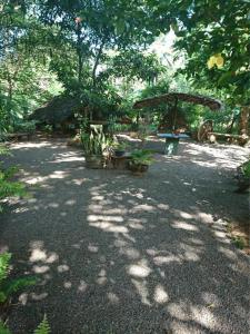 a park with a bench and a gazebo at Chandi Relax Hostel in Sigiriya
