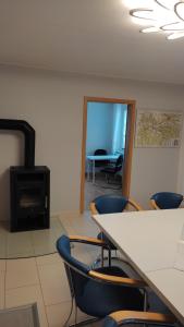 - une salle de réunion avec une table, des chaises et une cuisinière dans l'établissement Ferienhaus Meier, à Struppen