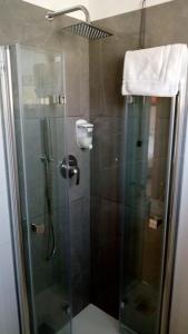 a shower with a glass shower stall with a shower at Hotel Cinzia in Porto Garibaldi