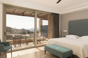 A bed or beds in a room at Paralos Irini Mare