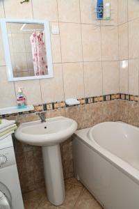 a bathroom with a sink and a bath tub at ASPERA Apartments in Kumanovo