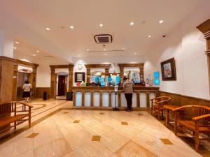 a person standing at a bar in a restaurant at Park View Hotel in Singapore