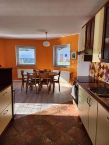 a kitchen and dining room with a table and chairs at Apartma Nika in Planina