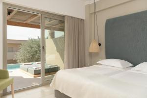 A bed or beds in a room at Paralos Irini Mare