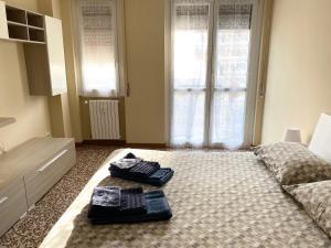 a bedroom with a bed with two towels on it at Casa Manolo Cesano Suite Apartment Milan in Cesano Boscone