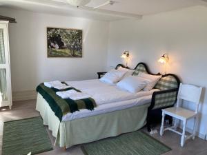 a bedroom with a bed and a table and a chair at Lunkaberg Bed & Breakfast in Simrishamn