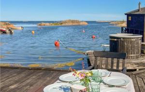 a table with plates of food on top of the water at Beautiful Apartment In Oskarshamn With Kitchen in Oskarshamn