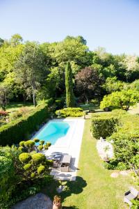 - une vue sur la piscine dans le jardin dans l'établissement LES CENT CIELS, à Salavas