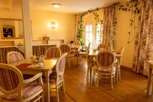 a dining room with wooden tables and chairs at Hotel Anker in Saalfeld