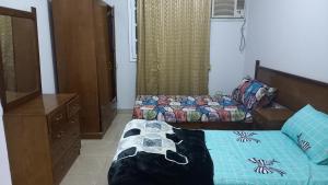 a bedroom with a bed with a dog on it at new ikea flat 1 in Hurghada