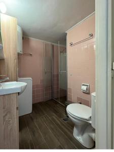 a bathroom with a toilet and a sink and a shower at So Athens - Charming 1BD flat, Large terrace, Acropolis view in Athens