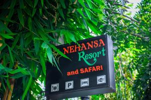 een bord voor een restaurant en saharan op een boom bij Nehansa Resort and safari in Tissamaharama