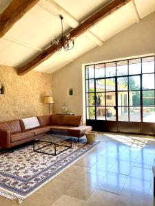 a living room with a couch and a table at Charming Farmhouse in Provence in Cavaillon