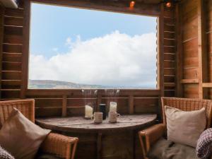 a room with a table and chairs and a window at Heather Hut at Copy House Hideaway in Barnoldswick