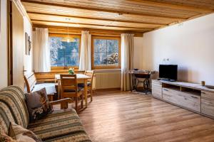 a living room with a couch and a dining room at Adlerhorst Amsel in Santa Valpurga