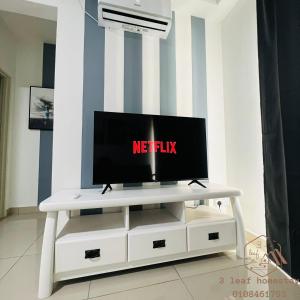 a television on a white tv stand in a living room at KULAI IOI MALL D'Putra Suites Near JPO Senai Airport 