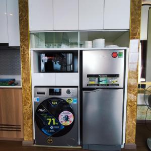 a kitchen with a large refrigerator and a microwave at Beach apartment apec Phú Yên in Tuy Hoa