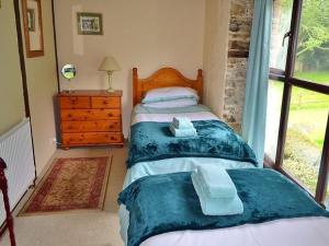 a bedroom with a bed with towels on it at Mill Cottage in Fowey