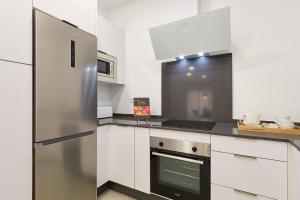 A kitchen or kitchenette at Soho Apartments in Malaga by Solaga Holiday Homes