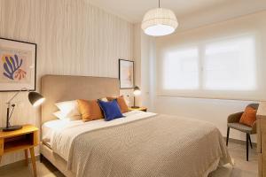 A bed or beds in a room at Soho Apartments in Malaga by Solaga Holiday Homes