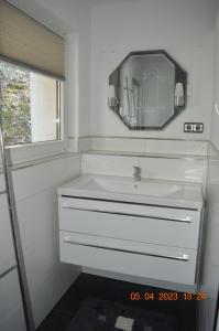 a bathroom with a white sink and a mirror at Dolomitenblick in Gerolstein