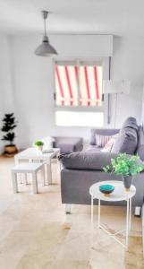 a living room with a couch and a table at Apartamento en el Albir, Alfaz del Pi Playa in Albir